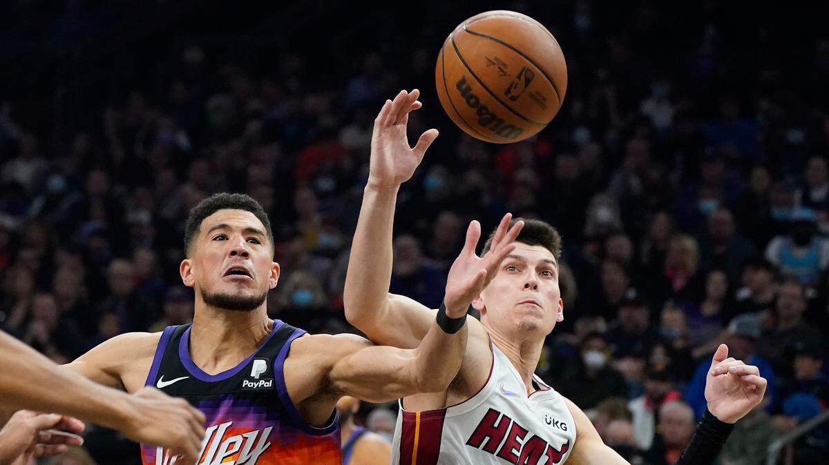 Former Kentucky stars Devin Booker, now with the Phoenix Suns, and Tyler Herro, now with the Miami Heat, battle for the ball during a game on Jan. 8. Both of their respective squads won conference championships.