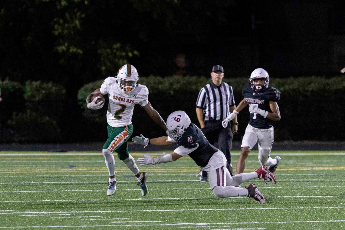 Frederick Douglass’ Aveion Chenualt (2) eluded a would-be Tates Creek tackler during one of his special teams returns in the Broncos’ 50-14 win at Tates Creek High School on Friday.