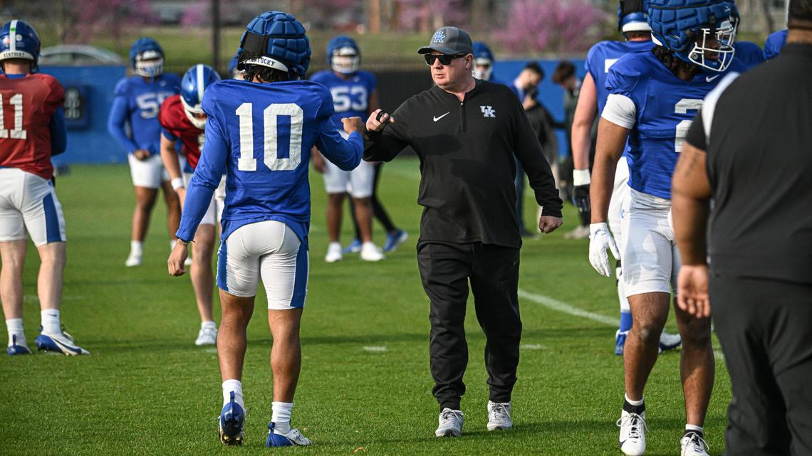 University of Kentucky football head coach Mark Stoops fist bumps with running back Jamarion Wilcox before an open practice on April 4.