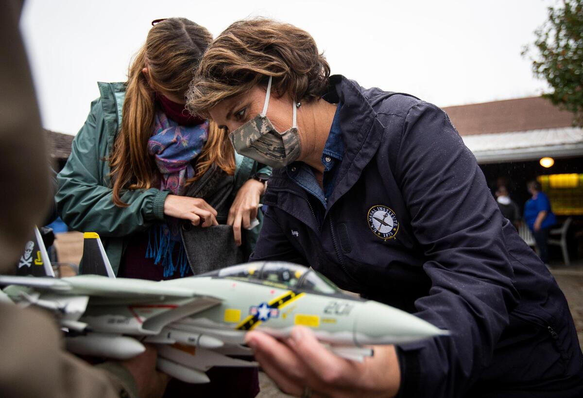 Democratic senate candidate Amy McGrath signs a model plane for Jackie Larkins, of Eubank, after a campaign event held at the Pioneer Playhouse in Danville, Ky., Wednesday, October 28, 2020.