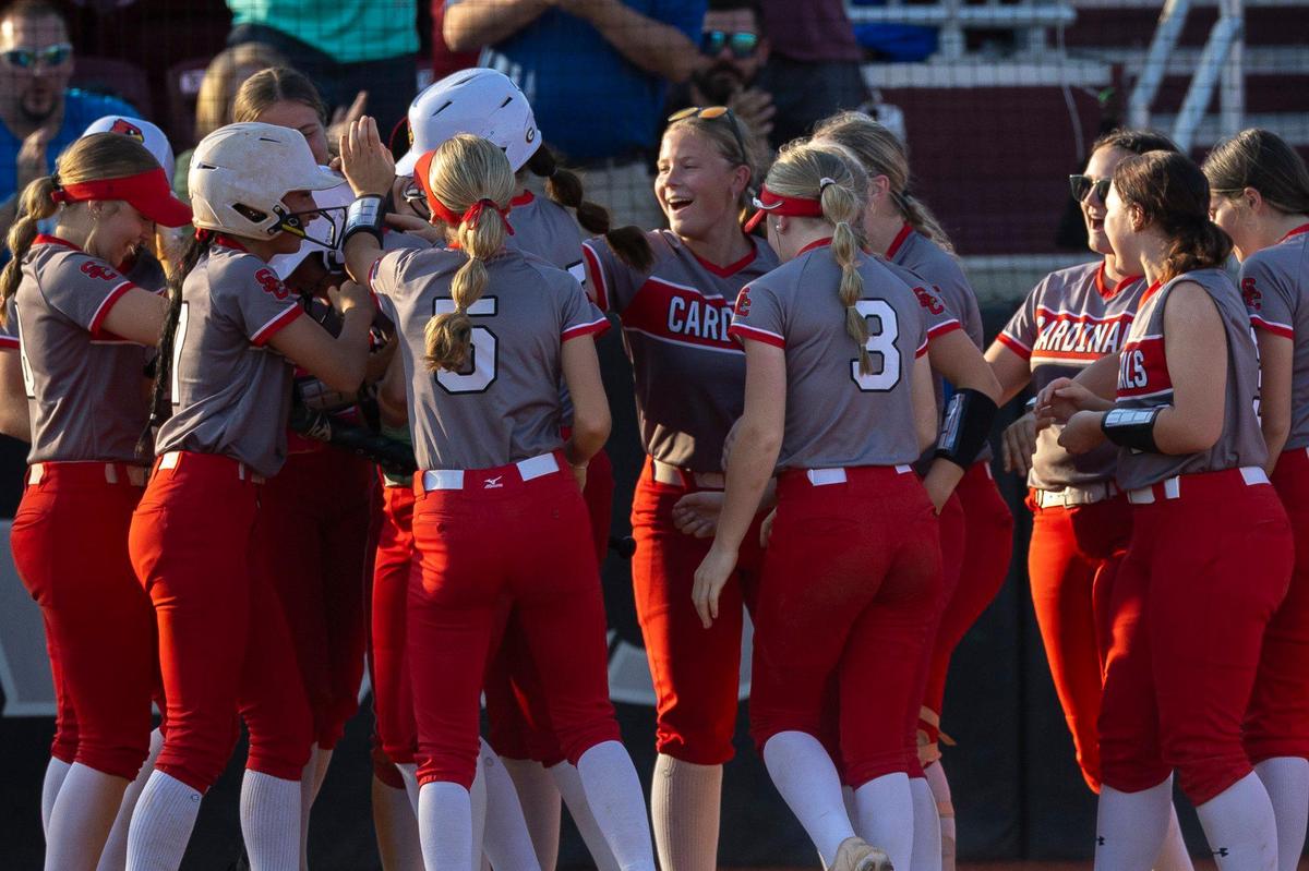 Scott County’s players celebrate a run during their 5-2 win over archrival Great Crossing in the 11th Region Tournament championship game at EKU on Thursday.