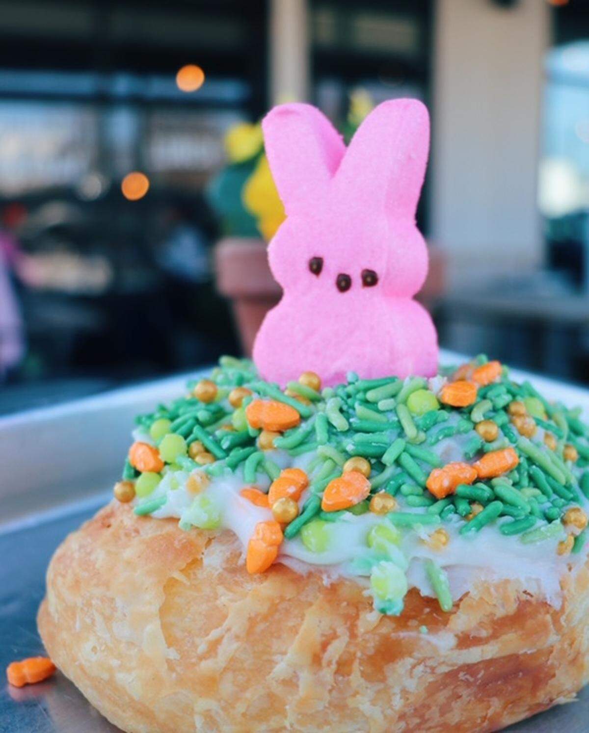 DV8 kitchen’s cinnamon roll, decorated for Easter with a Peep bunny and sprinkles.