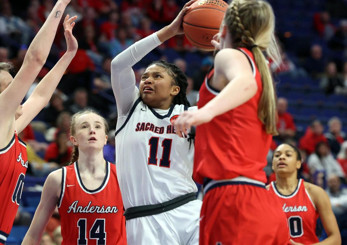 Sacred Heart’s ZaKiyah Johnson (11) shoots over Anderson County’s Paige Serafini (14) during the Girls’ Sweet 16 in Rupp Arena last March. Johnson is ranked as one of the top women’s college basketball recruits in the class of 2025.