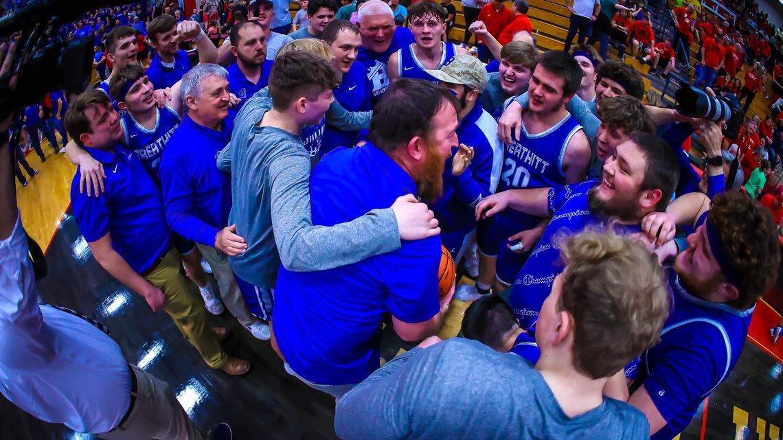 Breathitt County interim head basketball coach Kyle Moore (center) brought his team together for a postgame huddle after the Bobcats beat Perry County Central 62-46 to win the 14th Region championship for the first time since 1996.