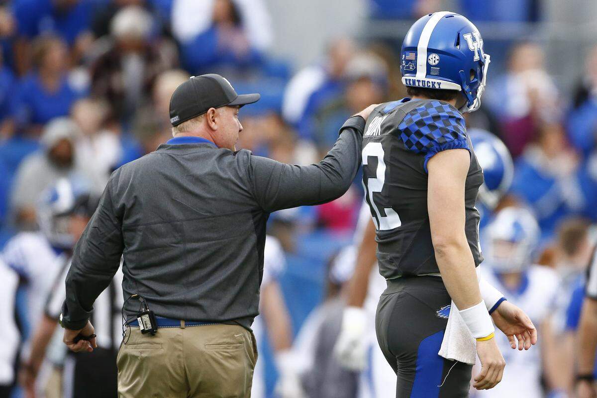 Kentucky Coach Mark Stoops encouraged quarterback Gunnar Hoak (12) during UK’s Blue-White spring football game Friday at Kroger Field. The Blue Team (starters) defeated the White Team (non-starters) 64-10.