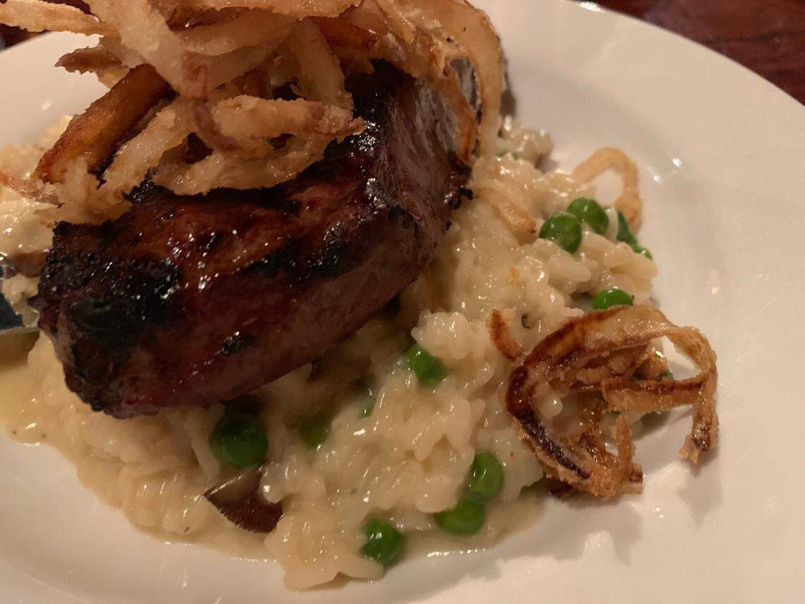 The Miller House: New York Strip topped with onion straws over a blue cheese and pea risotto
