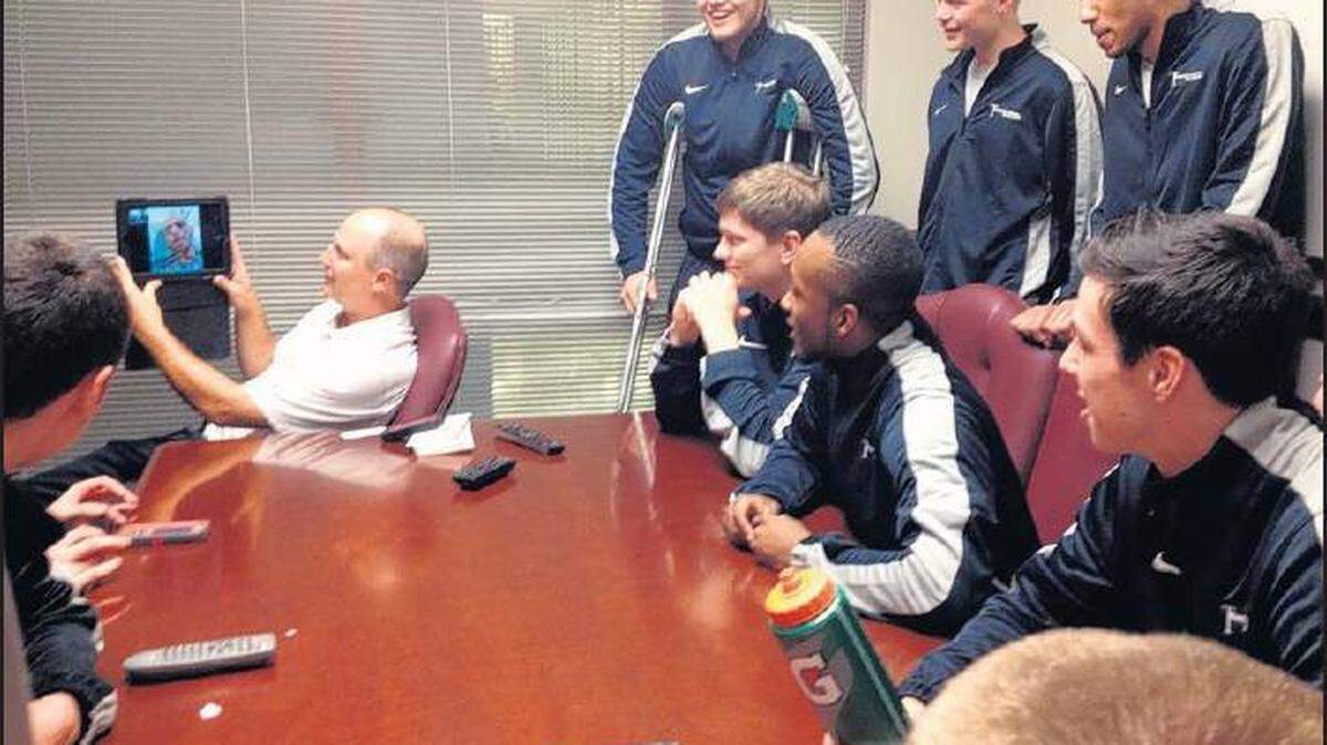 Before the "Battle on Broadway" with Kentucky, Transylvania men's basketball coach Brian Lane held up an iPad as the team conducted a video chat with fan Max Gjerde from his hospital bed.
