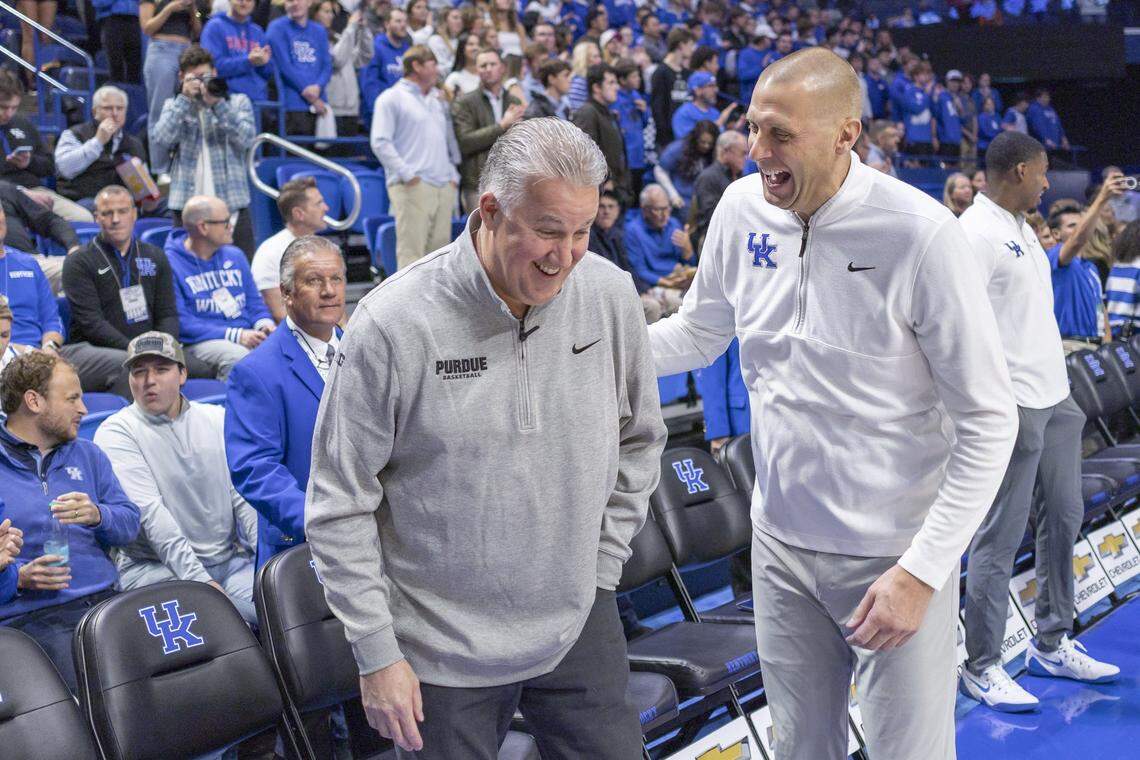 Kentucky coach Mark Pope, right, spoke with Purdue head man Matt Painter, left, before the No. 9 Wildcats beat the No. 1 Boilermakers 78-65 in an NCAA men’s college basketball exhibition game last Friday at Rupp Arena. 