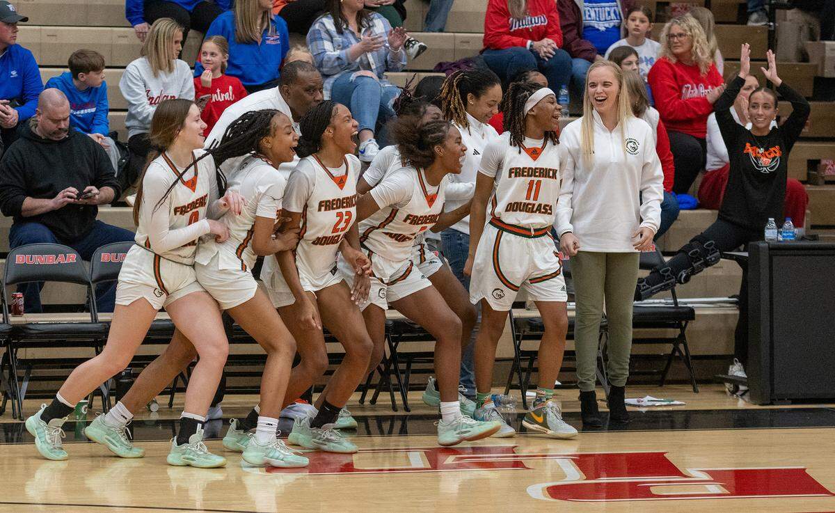 The Frederick Douglass Broncos celebrate the school’s second trip to the Girls’ Sweet 16 state tournament in three years after winning the 11th Region Tournament on Saturday night.