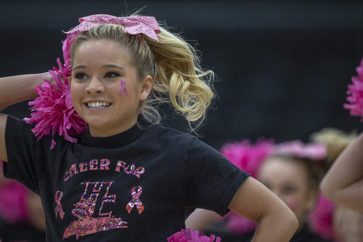 Harlan County cheerleader Ally Alred performs during a pep assembly.