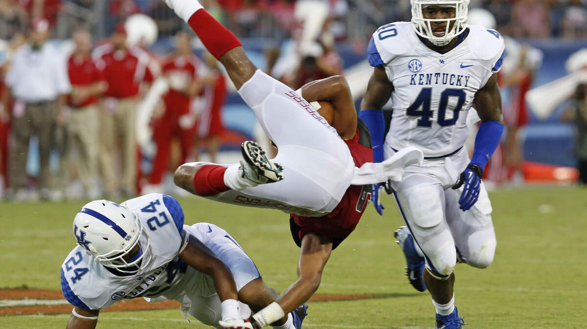 Blake McClain (24) tackled WKU wide receiver Joel German (6) during last weekend's opener. "We knew that he was going to be one of our best 11," UK defensive coordinator D.J. Eliot said.      
