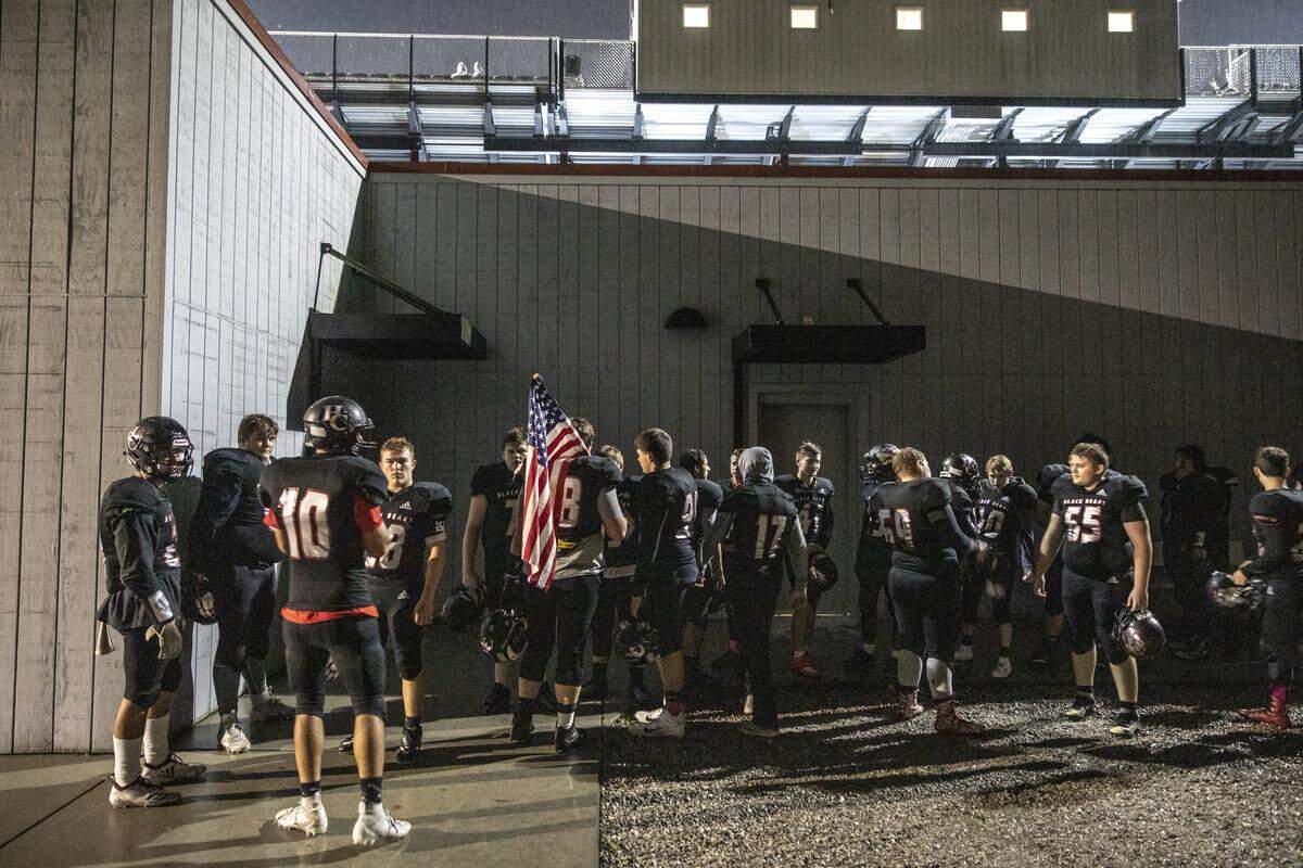 Members of the Harlan County football team wait to take the field.