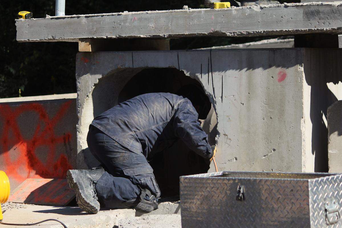 A student with the structural collapse training course at the Lexington Fire Department training facility crawls into a tunnel to simulate search and rescue operations on Sept. 29, 2022.