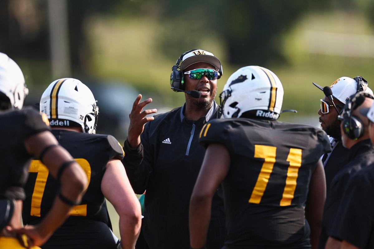 Woodford County head coach Dennis Johnson called to his players during a loss to Bullitt East in Harrodsburg on Aug. 19. The Yellow Jackets have won five straight since.