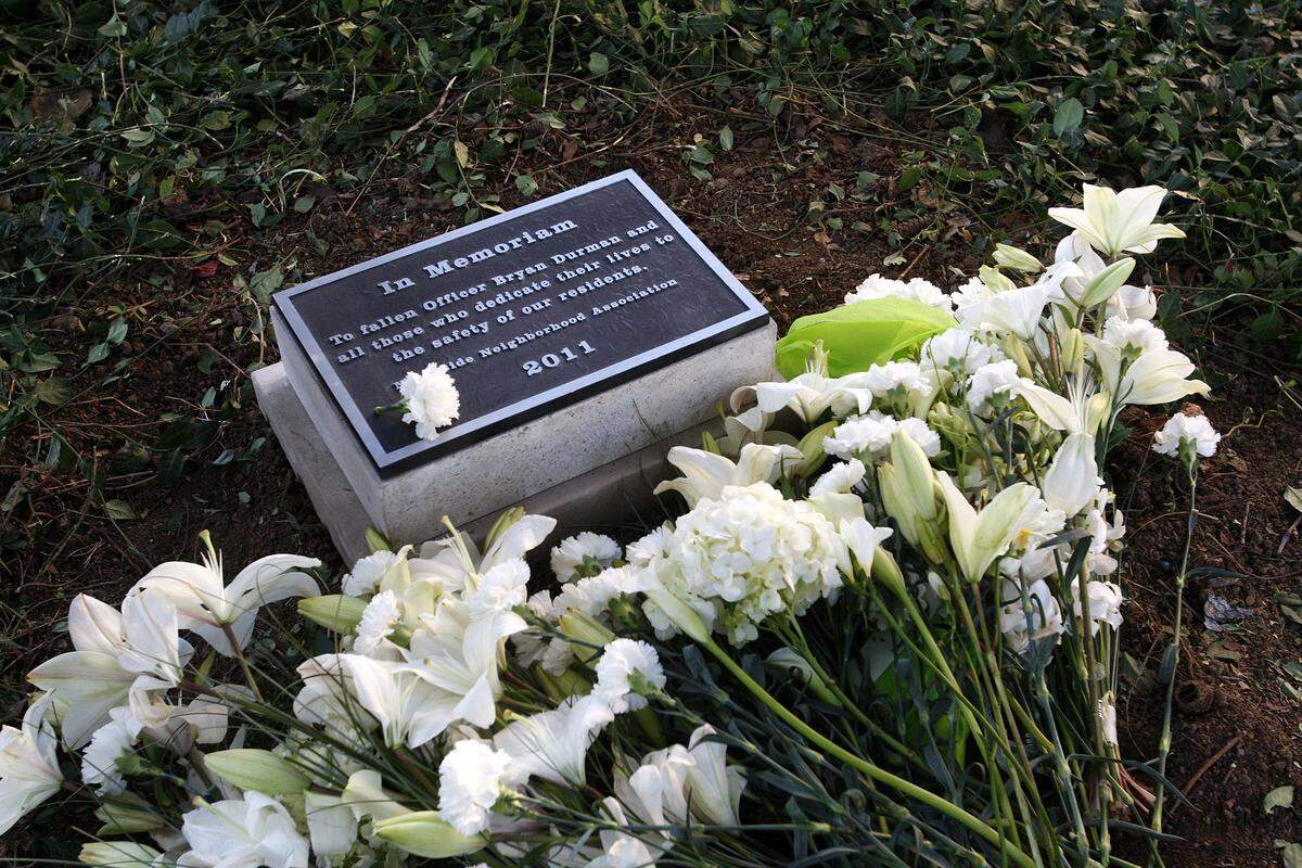 Flowers placed around the memorial to Officer Bryan Durman, who was killed in the line of duty in April 2010, at Founders Park in Lexington, Ky., Monday, October 3, 2011. Photo by Matt Goins 12741