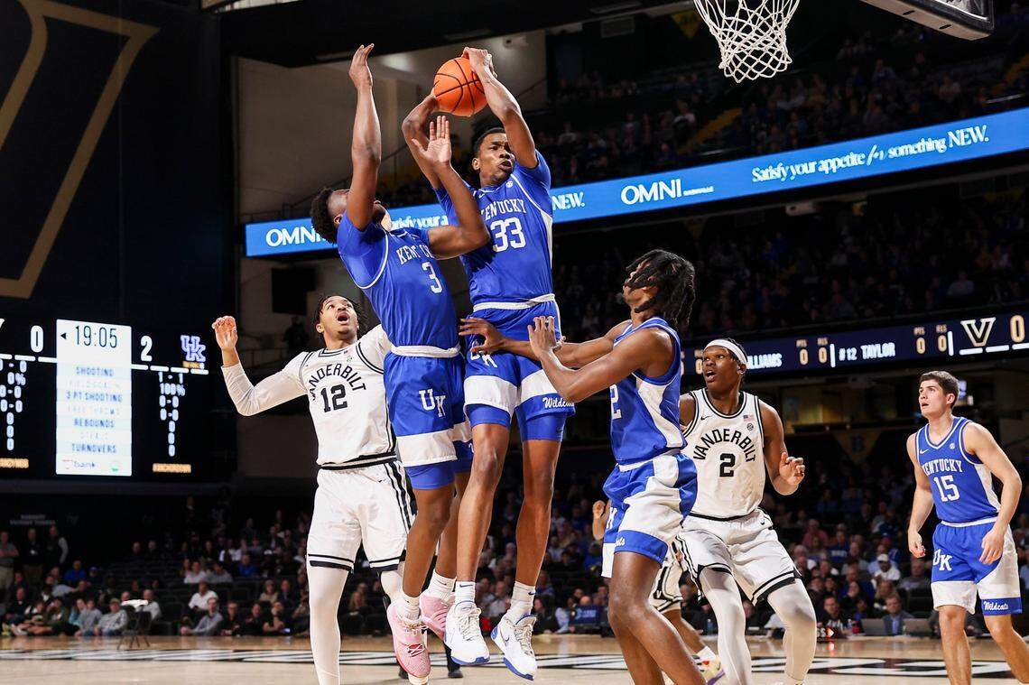 Kentucky forward Ugonna Onyenso (33) grabs a rebound away from Vanderbilt guard Evan Taylor (12) during Tuesday’s game.