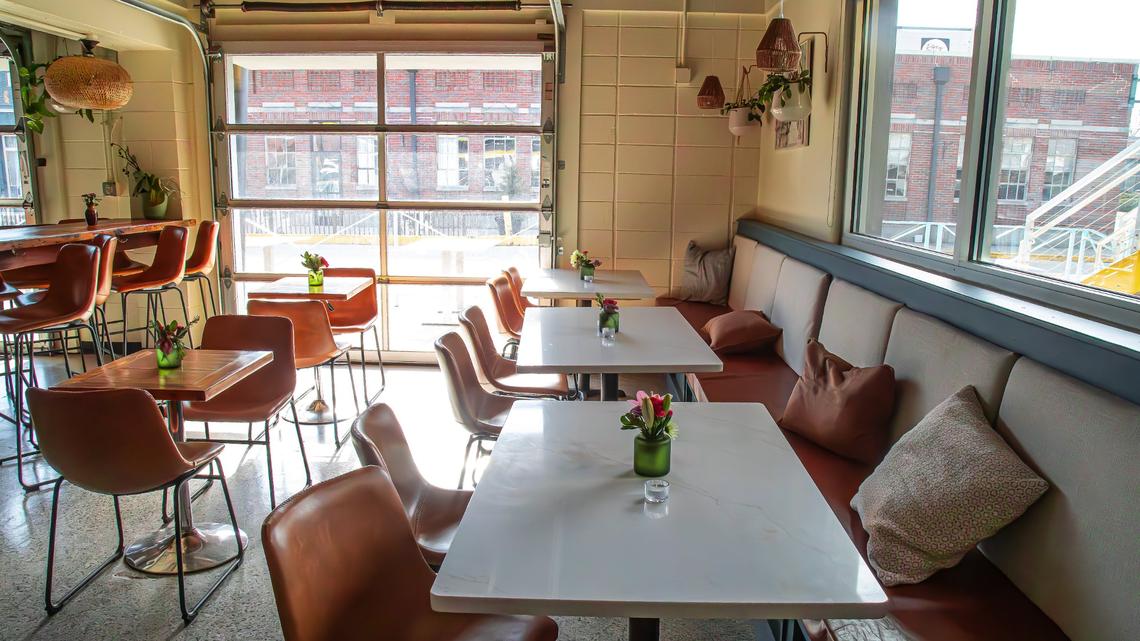 A sun-drenched seating and dining area with custom-made countertops at Minton’s new 701 National Ave location.