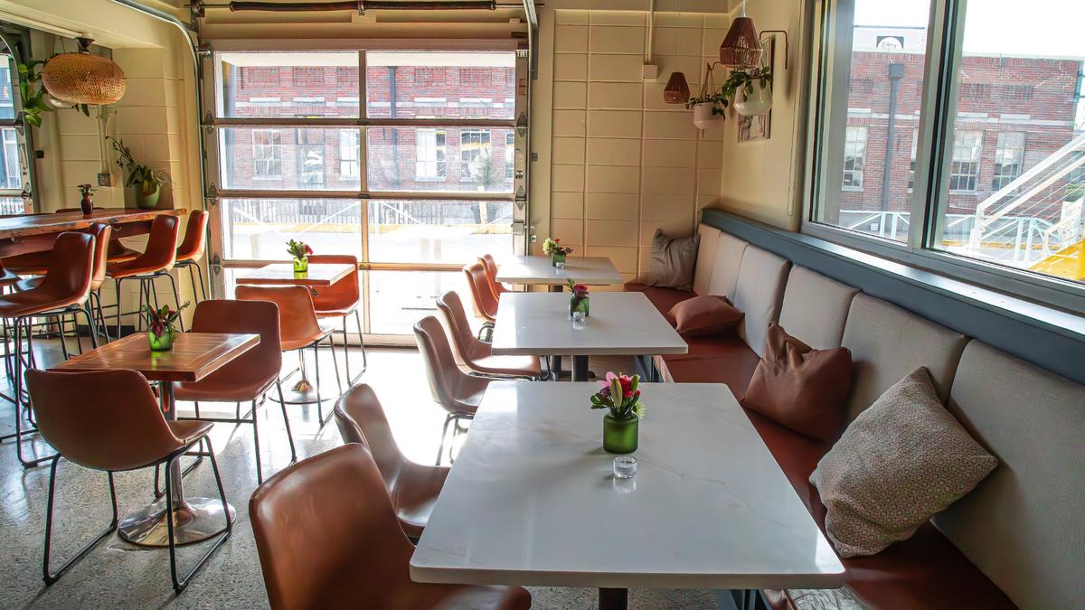 A sun-drenched seating and dining area with custom-made countertops at Minton’s new 701 National Ave location.