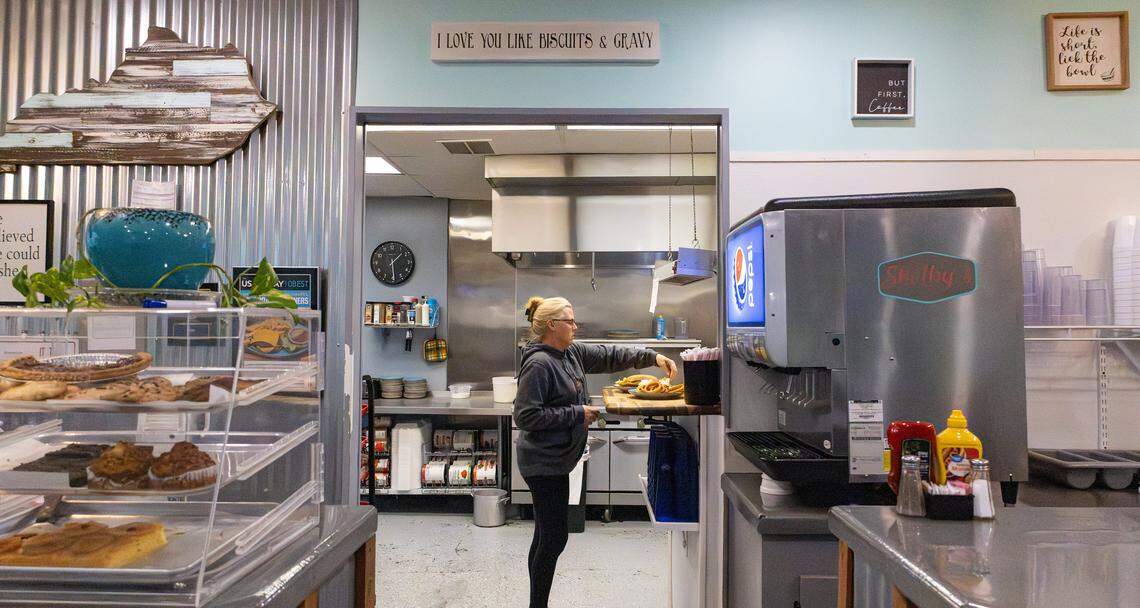 Shelby Keith, owner of Shelby’s Diner, assists in the kitchen with order preparation and waits tables on Nov. 19, 2025, in Frankfort, Ky. 
