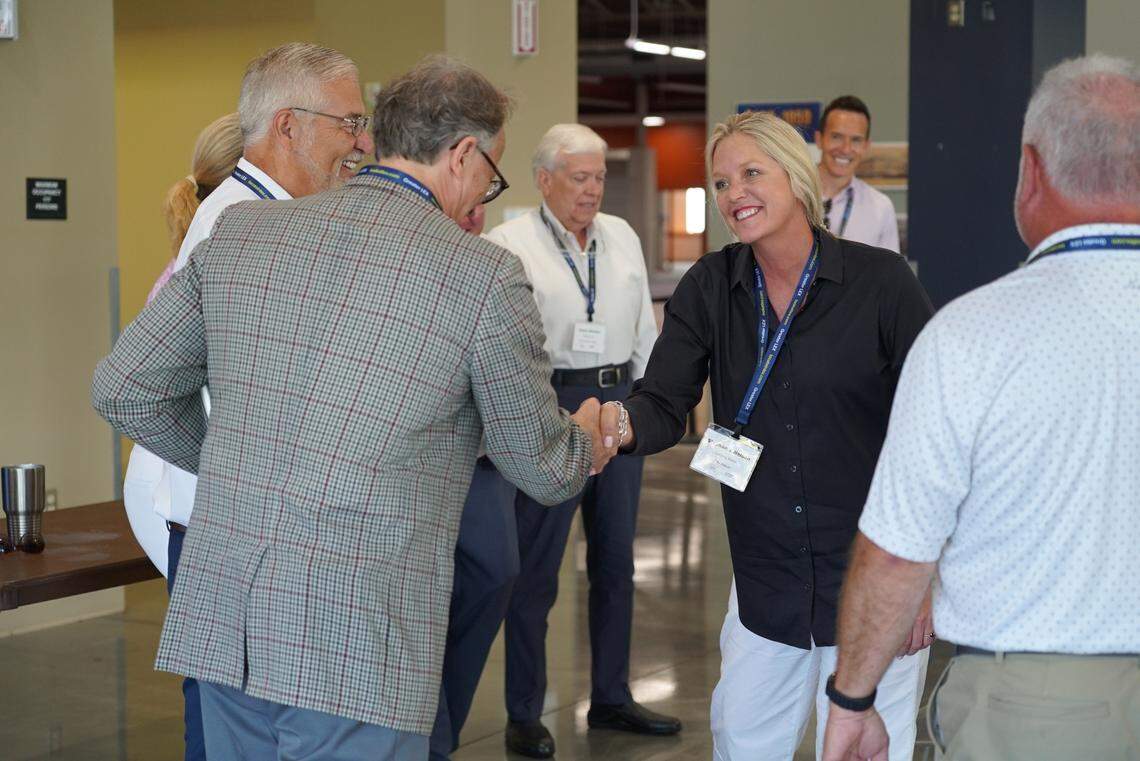 U.S. Sen. Mitch McConnell’s field representative Stephanie Nelson shakes hands with another community leader during an economic development simulation hosted by Commerce Lexington Monday, June 23, 2025, at the Bluegrass Community & Technical College Winchester - Clark County campus.