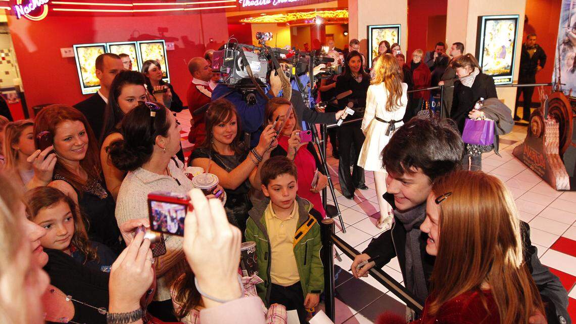 Chronicles of Narnia star, Skandar Keynes posed with Abbey Henson, age 9, during a premiere screening of the third film in the series, "The Voyage of the Dawn Treader at Regal Cinema at Hamburg Pavilion in Lexington, Ky., on Thursday Dec. 9, 2010. The premier was in town as a prize to students at Chrisitan Academy in Louisville, who won a contest to see what organization could put together the most shoebox gift boxes for needy children around the world. Louisville does not have a Regal Cinema, a sponsor of the contest. Photo by Pablo Alcala | Staff