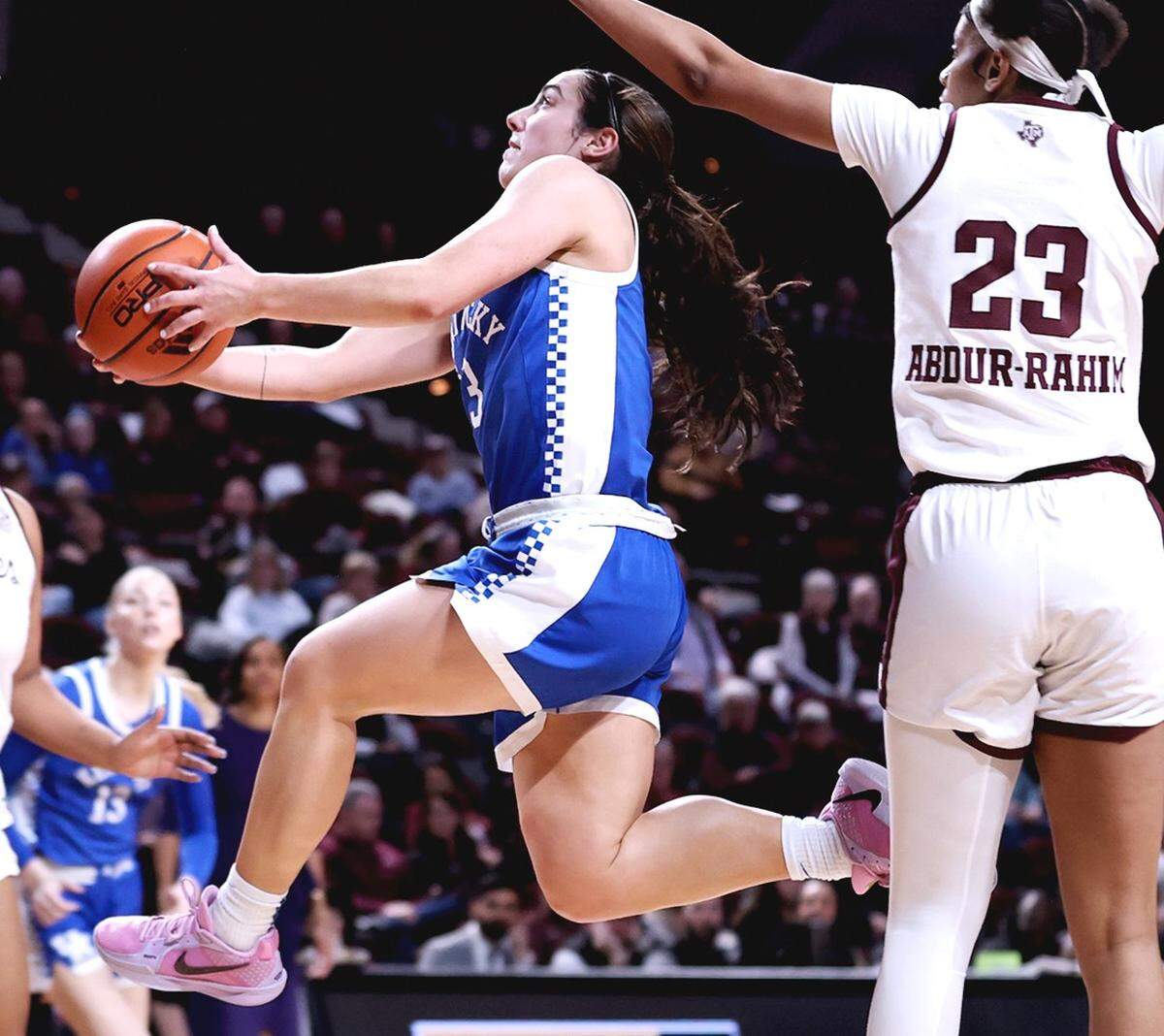 Georgia Amoore drives to the basket against Texas A&M’s Amira Abdur-Rahim during the Wildcats’ game in College Station, Texas, on Thursday night. Amoore missed all eight of her 3-point attempts but finished with 15 points.