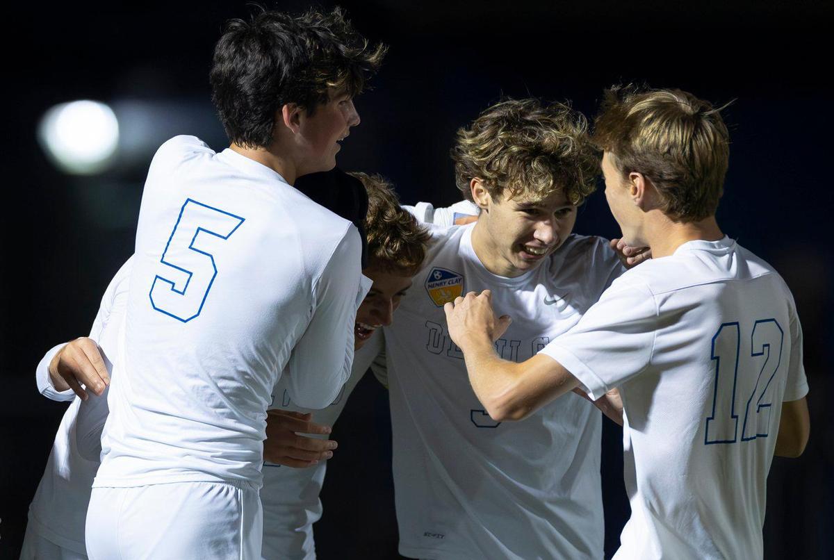 Henry Clay’s Braden Cundiff (3) is congratulated by his teammates, including Connor Taylor, left, Nathan Harvey (5) Marco Messerli center and James Clay (12) after scoring the opening goal of their game against Paul Laurence Dunbar during the boys 11th Region tournament semifinals at Henry Clay High School on Wednesday.