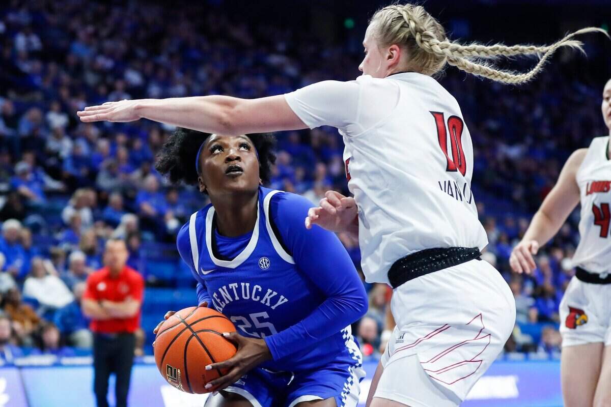 Kentucky’s Adebola Adeyeye, left, looks for a shot around Louisville’s Hailey Van Lith on Dec. 11, 2022.