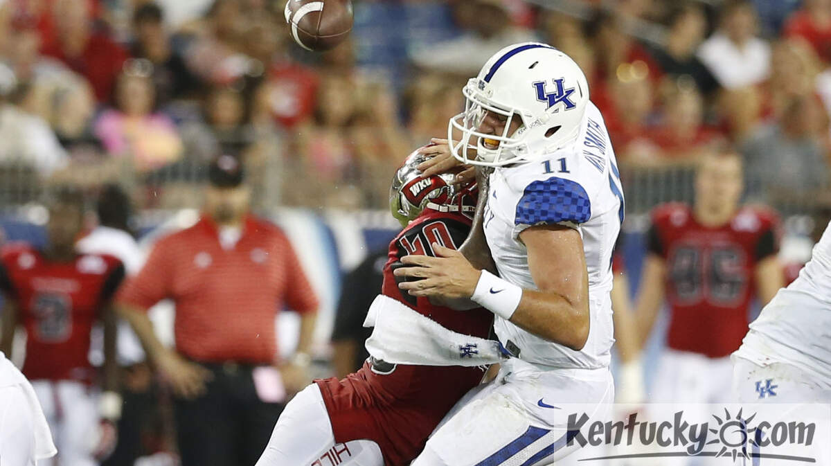 Kentucky Wildcats quarterback Maxwell Smith (11)  fumbled the ball as he was hit by Western Kentucky Hilltoppers linebacker Bar'ee Boyd (40) as WKU defeated UK 35-26 at LP Field on Saturday August 31, 2013 in Nashville, Tenn. Photos by Mark Cornelison | Staff