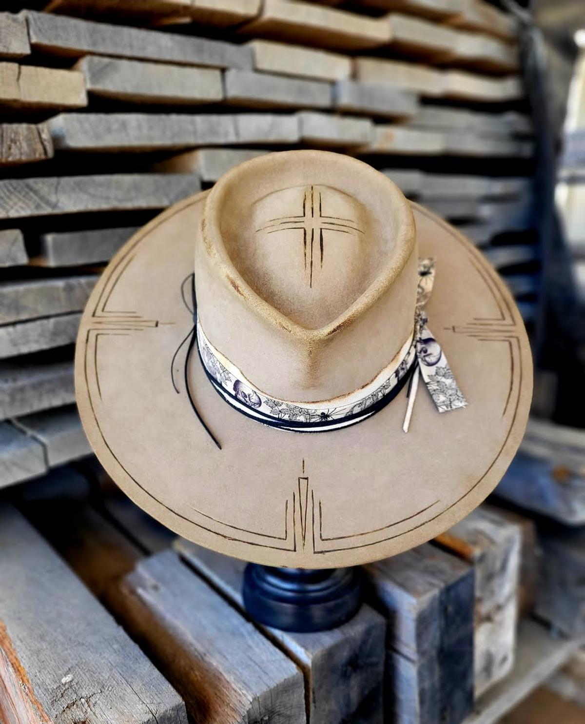 A hat made by sculptor Tony Higdon includes designs burned into the felt.