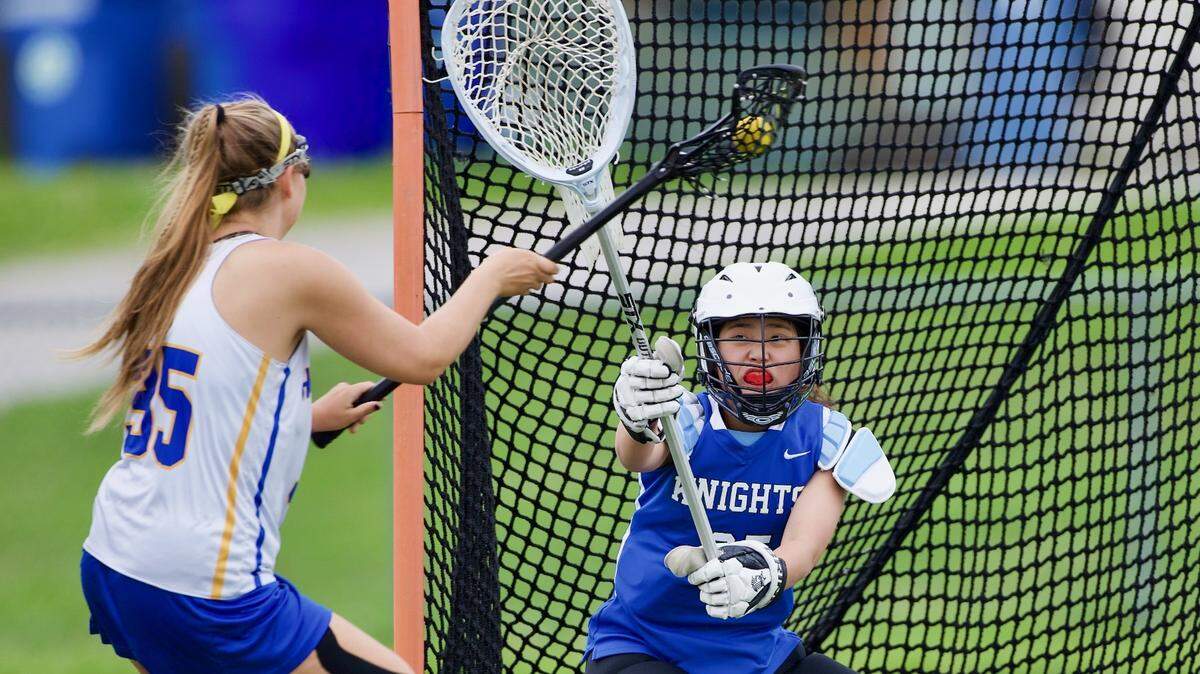Lexington Catholic’s Olivia Arms gets ready to stop a shot on goal from Henry Clay’s Grace Waechter during a May 2, 2021 game at Henry Clay. The boys’ and girls’ teams at Henry Clay each won the 2021 Commonwealth Lacrosse League state championship.