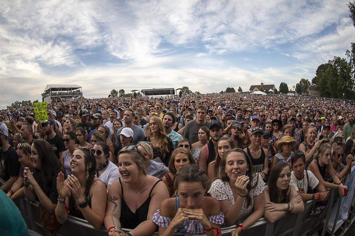Festival goers wait for Tyler Childers to take the stage during the Railbird Festival at Keeneland in Lexington, Ky., Sunday, Aug. 11, 2019.