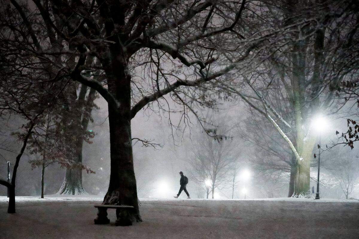 A man walks through campus along a snow covered sidewalk at the University of Kentucky in Lexington, Ky., Wednesday, Jan. 27, 2021. 