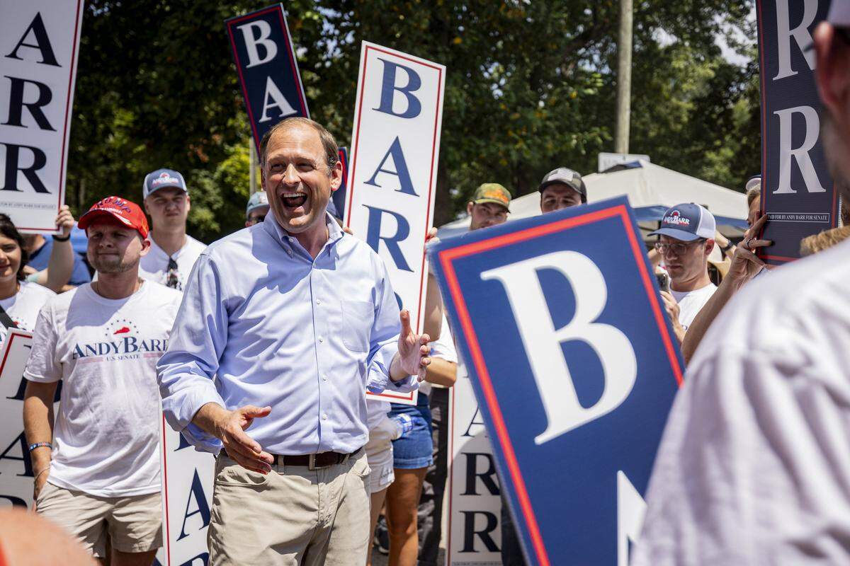 Andy Barr, center, smiles at his supporters during Fancy Farm Picnic on Saturday, Aug. 2, 2025, at St. Jerome Church in Fancy Farm, Ky.