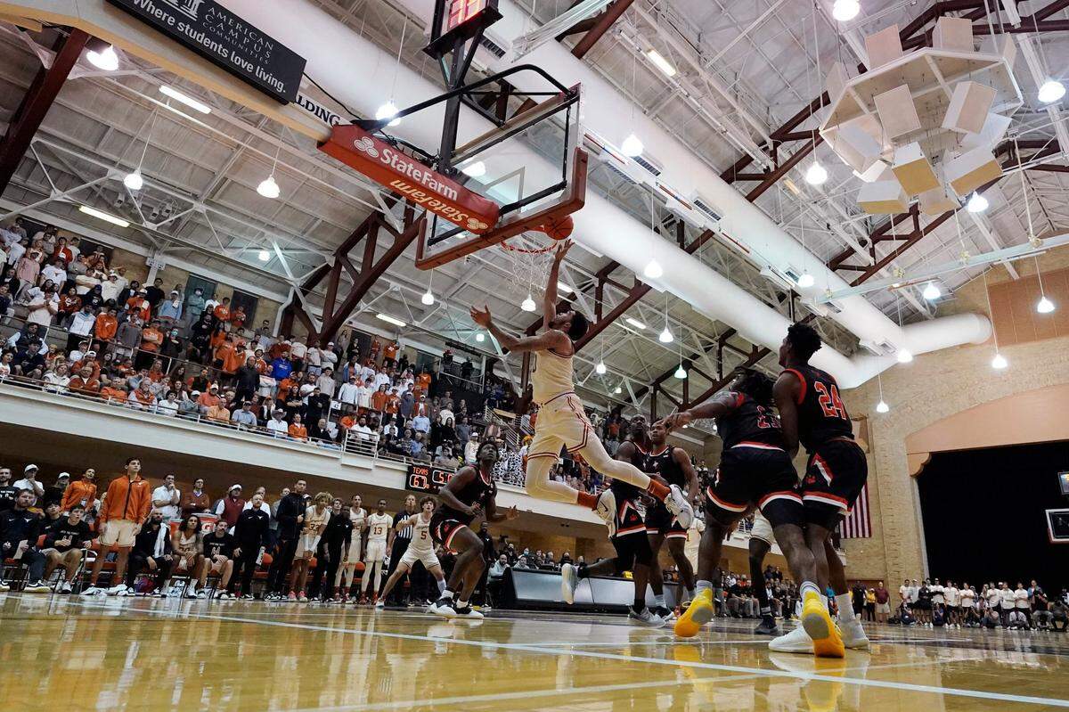 Texas forward Timmy Allen (0) scores against Sam Houston State during the second half of the Longhorns’ game in Gregory Gym on Monday night. The contest took place in front of a students-only crowd.