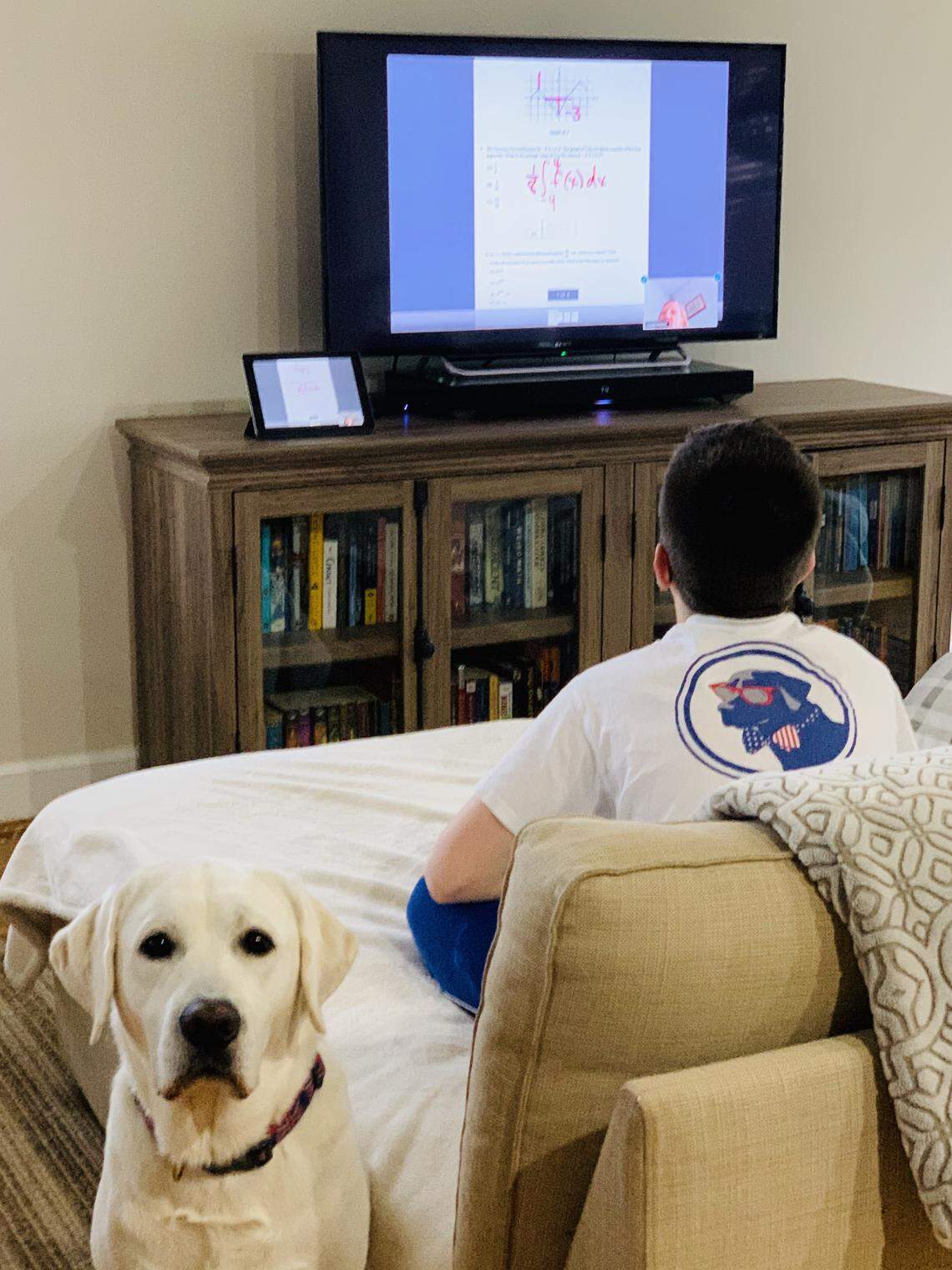 Grayson Kemplin, an AP Calculus student at Lexington’s Henry Clay High School, studies from home “mirroring” the platform Zoom from the ipad onto the bigger tv screen using apple TV.