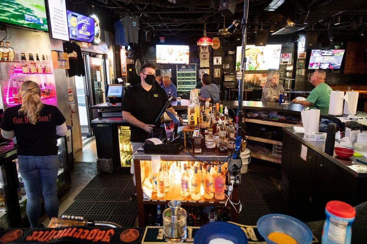 Jason Vaughn, general manager, works behind the bar at Madison Garden Bar and Grill in Richmond. The bar houses 127 bourbons, the largest selection in the city.