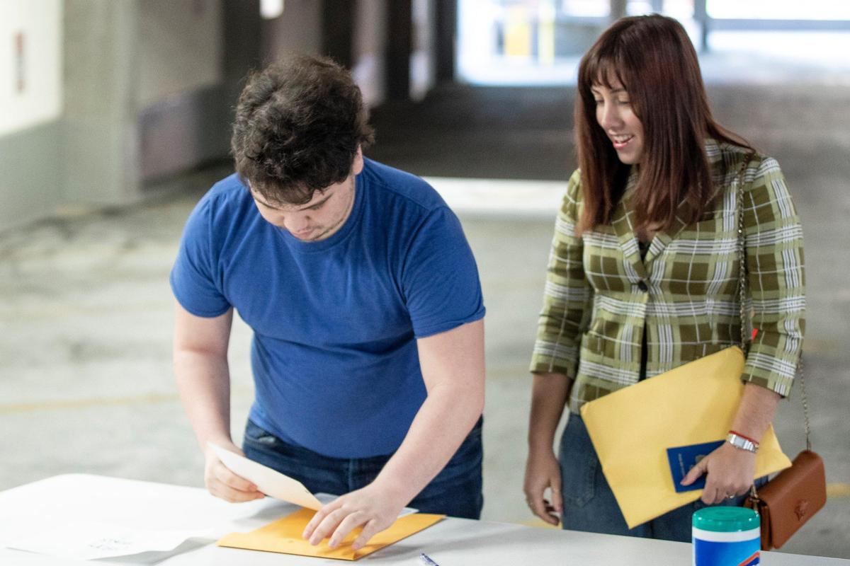 Alberto Rojas and Claudia Piloto obtain a marriage license outside the County Clerk’s office on the second floor of the Helix Garage in downtown Lexington, Ky., on Thursday, April 9, 2020.
