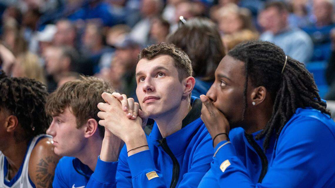 Kentucky’s Zvonimir Ivisic, second from right, watches from the bench during Friday’s exhibition game against Georgetown College.