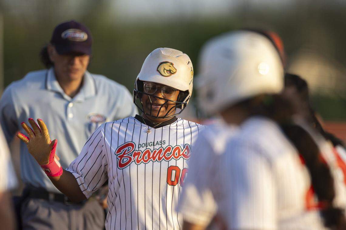 Frederick Douglass' Jarynn Bowman (00) is congratulated by her teammates after hitting a home run during a game against Lafayette at Frederick Douglass High School in Lexington, Ky., on Tuesday, April 14, 2026.