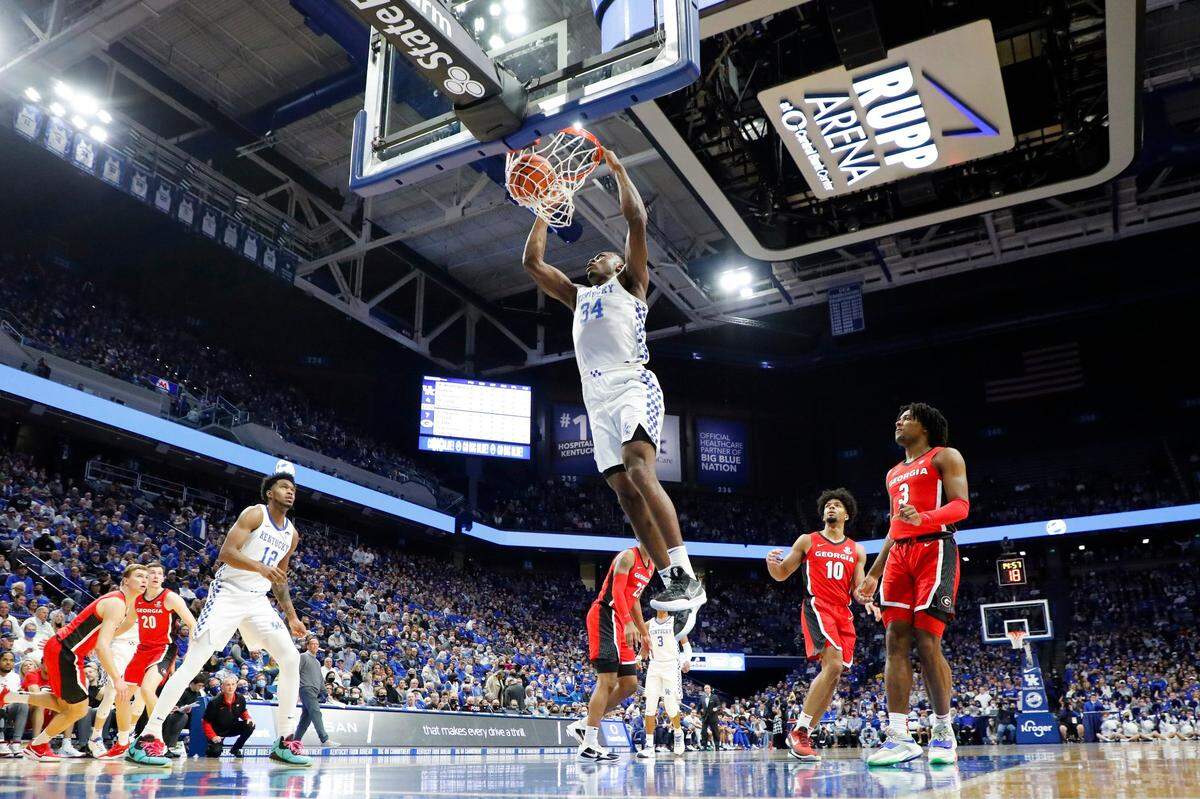 Kentucky Wildcats forward Oscar Tshiebwe (34) slam dunks the ball over Georgia Bulldogs guard Aaron Cook (10) during a game at Rupp Arena in Lexington, Ky., Saturday, Jan. 8, 2022.