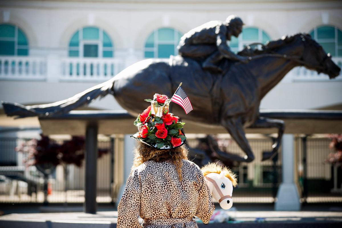 Abbie Funke, of Dayton, Ohio, gazed at the Barbaro Memorial Statue near the entrance of Churchill Downs on Saturday. The Kentucky Derby was postponed until Sept. 5 due to the spread of COVID-19.