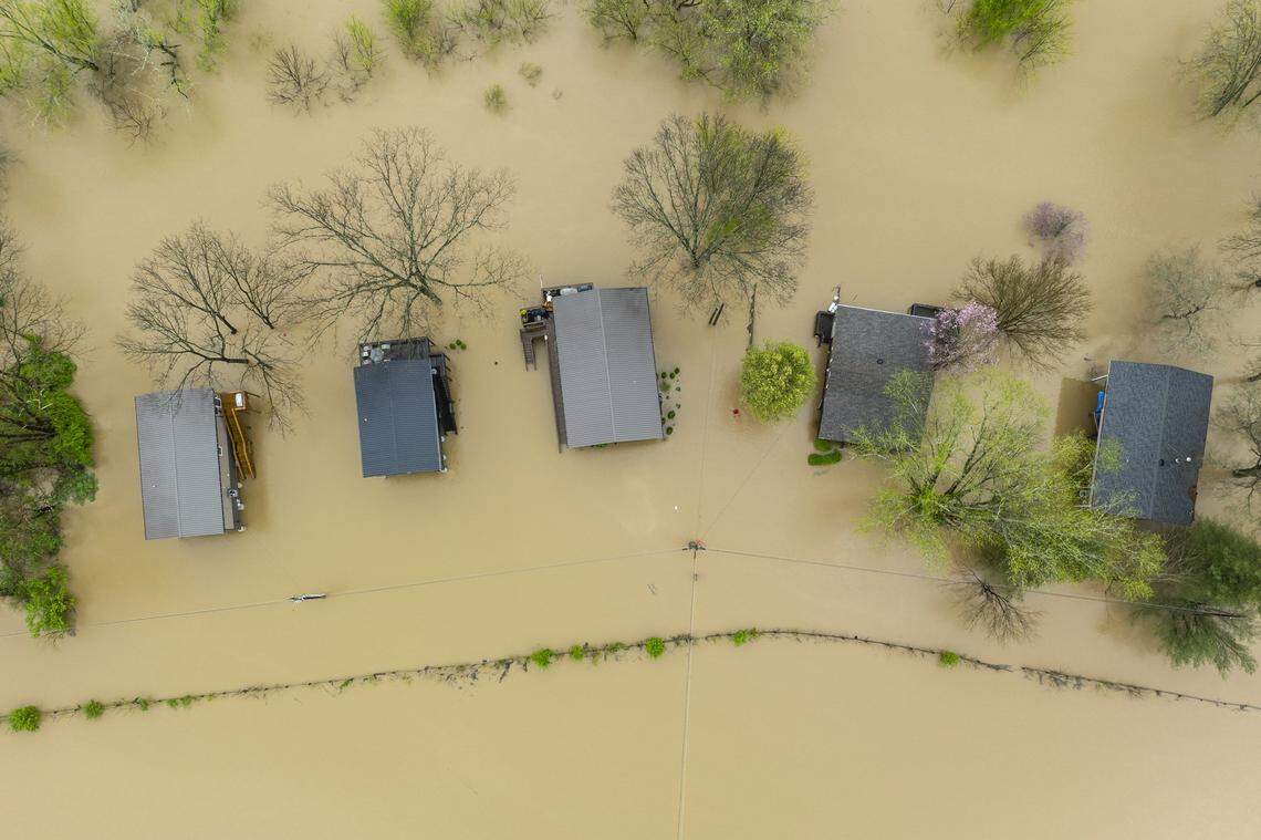 The Kentucky River surrounds homes on Dix Drive near High Bridge in Jessamine County on Saturday, April 5, 2025.