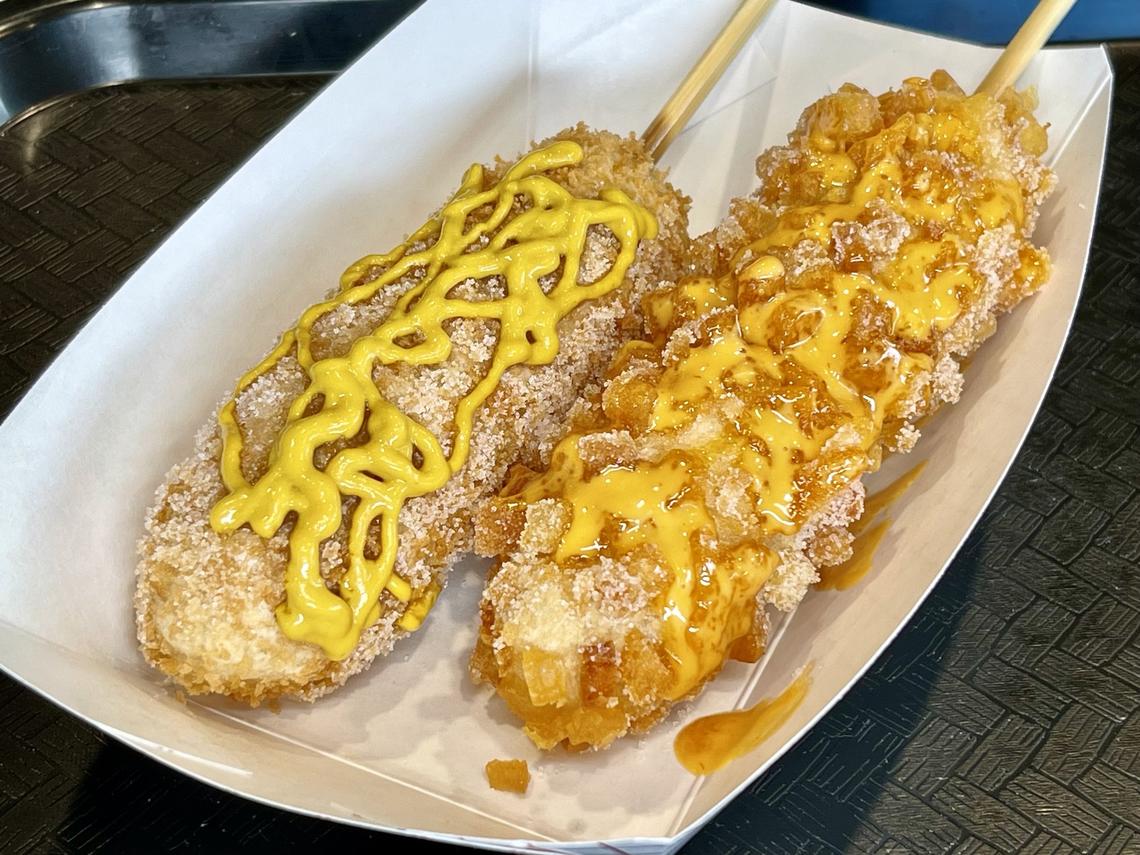 Mozzarella and Sausage with Mustard Corn Dog, left, and Potato Sausage Mozzarella Corn Dog with Spicy Mayo from Han Woo Ri on UK Campus.