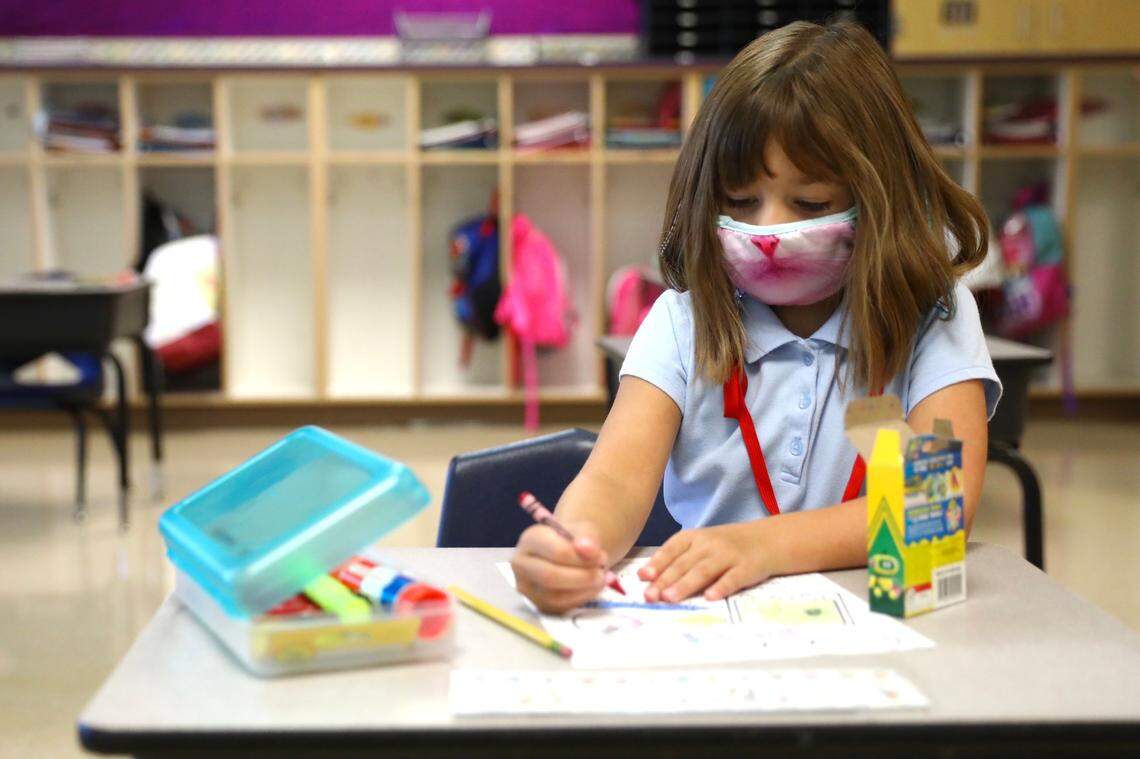 Piper Nowaczewski, a first grade student in Kelli Coleman’s class at Good Shepherd Catholic School in Frankfort, Ky., colors an “all about me” form on the first day of school, Monday, Aug. 17, 2020.