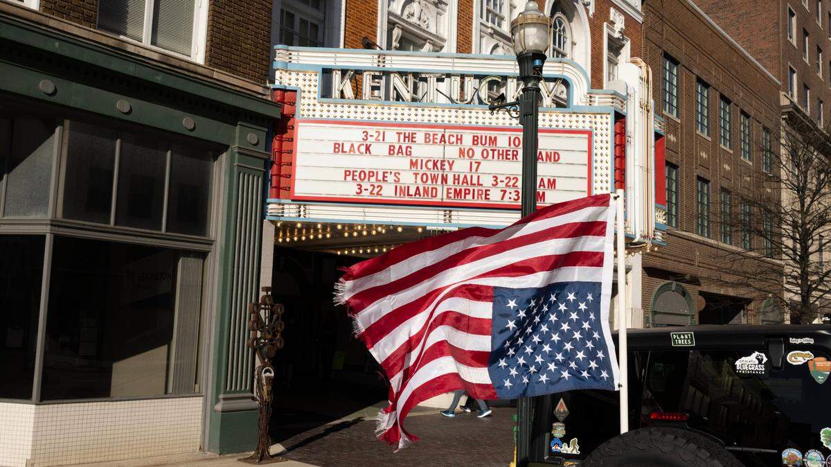A vehicle parked outside the People’s Town Hall inverted the American flag as a sign of distress. The event was held on Saturday morning at the Kentucky Theatre, Lexington, KY. Rep. Andy Barr declined an invitation to attend. An overflow crowd of greater than 1,100 people did attend.