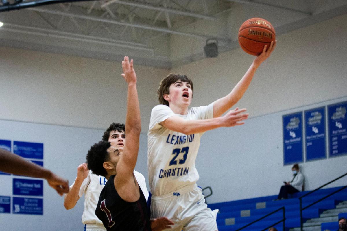 Lexington Christian Academy’s Tyler Hall drove against Tates Creek’s Camdyn Combs on Tuesday night. Hall finished with 14 points.