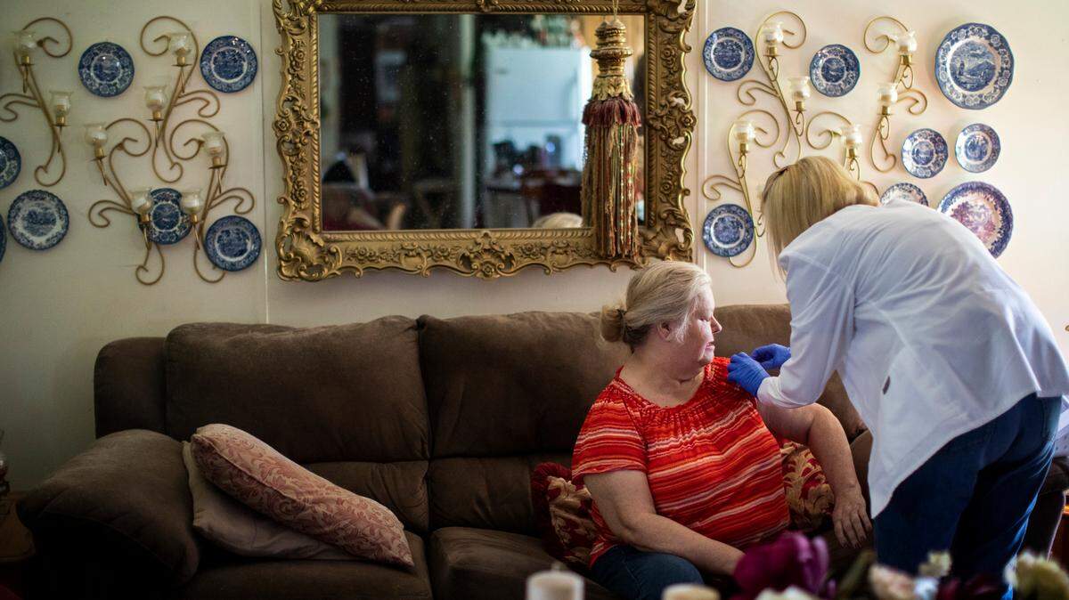 Donna Rowe prepares for her second dose of the Moderna vaccine in her home outside of Vanceburg, Ky.