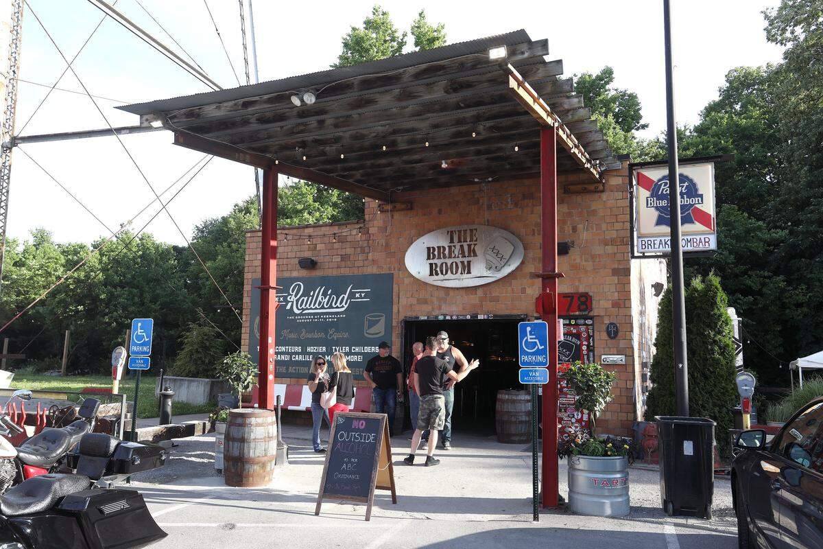 Patrons socialized outside The Break Room at the Pepper Distillery. The bar has kept its dive feel even though it is in the middle of one of the city’s white-hot entertainment districts.