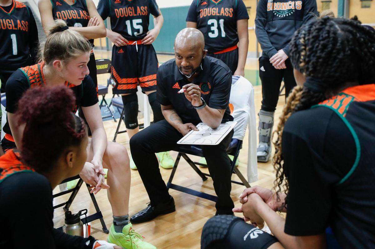 Frederick Douglass head coach Daryl Moberly talked with the team during their 42nd District semifinal against Sayre at Bryan Station High School on Wednesday night.